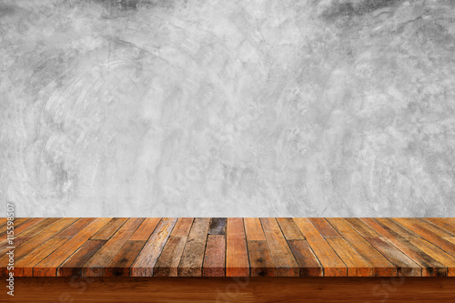 Empty wooden table with bare concrete wall background.