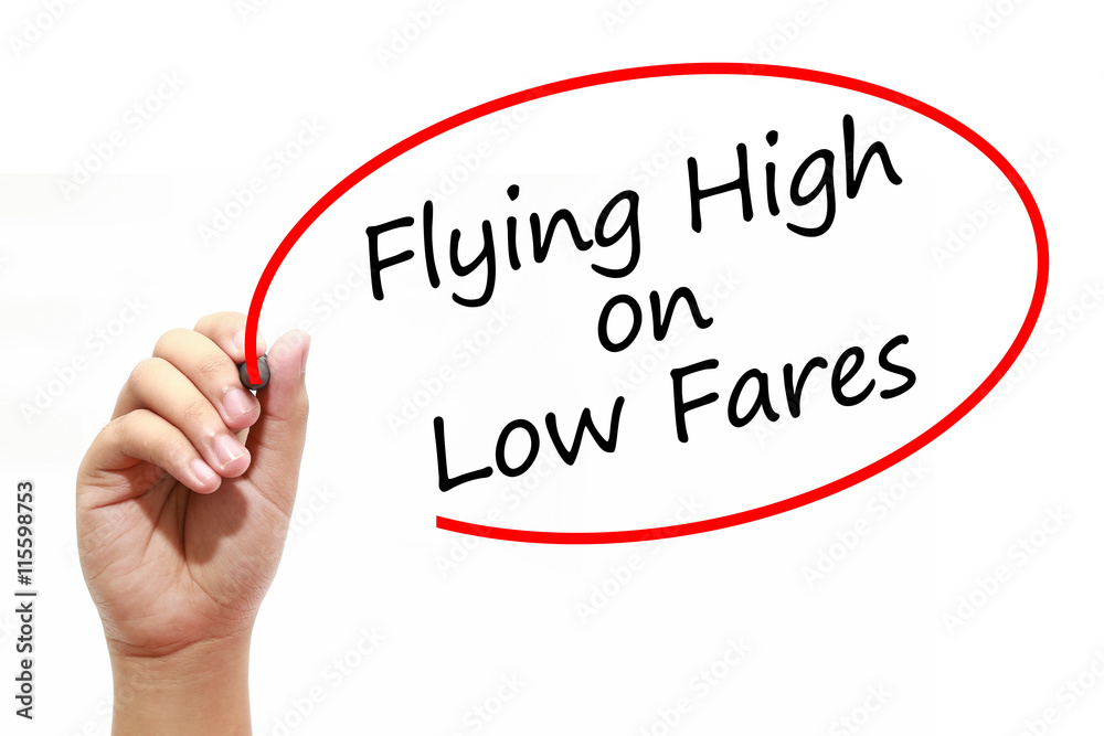 Man Hand writing Flying High on Low Fares with marker on transparent wipe board. Business, internet, technology concept. Man Hand writing Flying High on Low Fares with marker on transparent wipe board. Business, internet, technology concept.