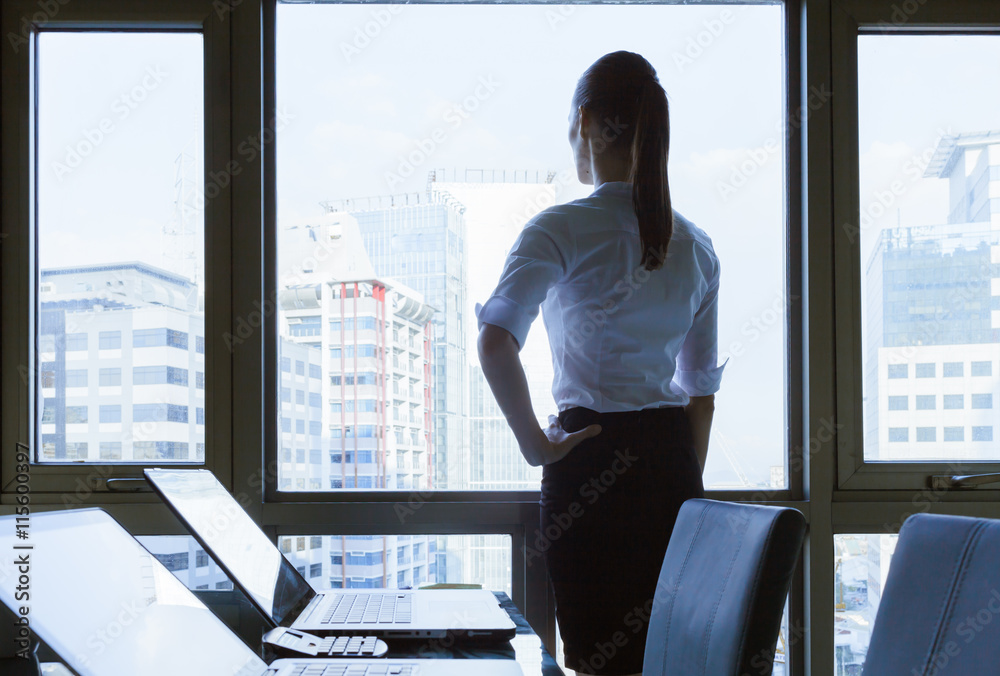 © kieferpix - Female looking out from her office window. © kieferpix - Female looking out from her office window.