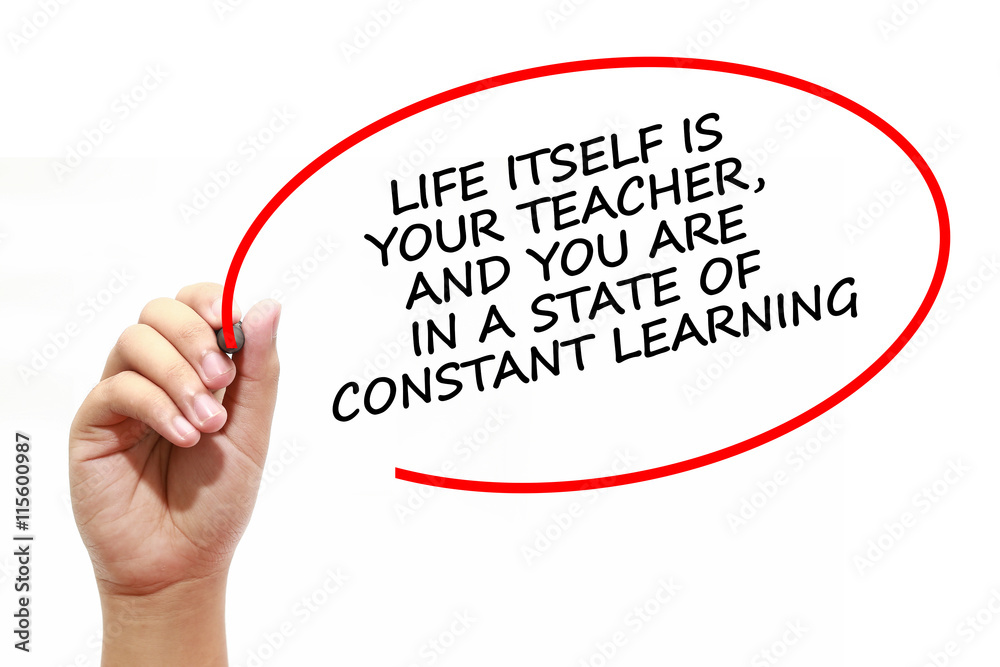 Fototapeta premium Man writing LIFE ITSELF IS YOUR TEACHER, AND YOU ARE IN A STATE OF CONSTANT LEARNING with marker on transparent wipe board.