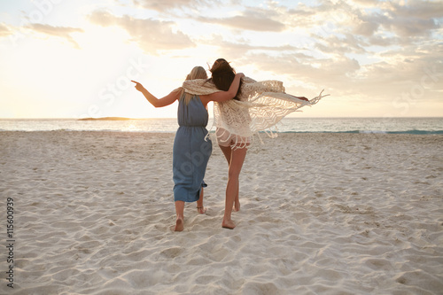 Woman friends enjoying a day on the beach photo