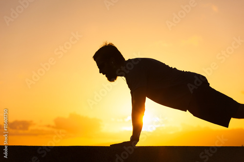 Fototapeta Naklejka Na Ścianę i Meble -  Man doing push ups outdoors

