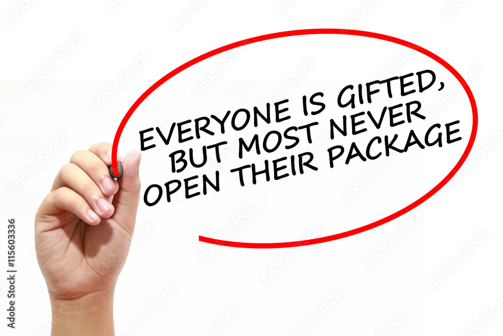 Fototapeta premium Man writing EVERYONE IS GIFTED, BUT MOST NEVER OPEN THEIR PACKAGE with marker on transparent wipe board.