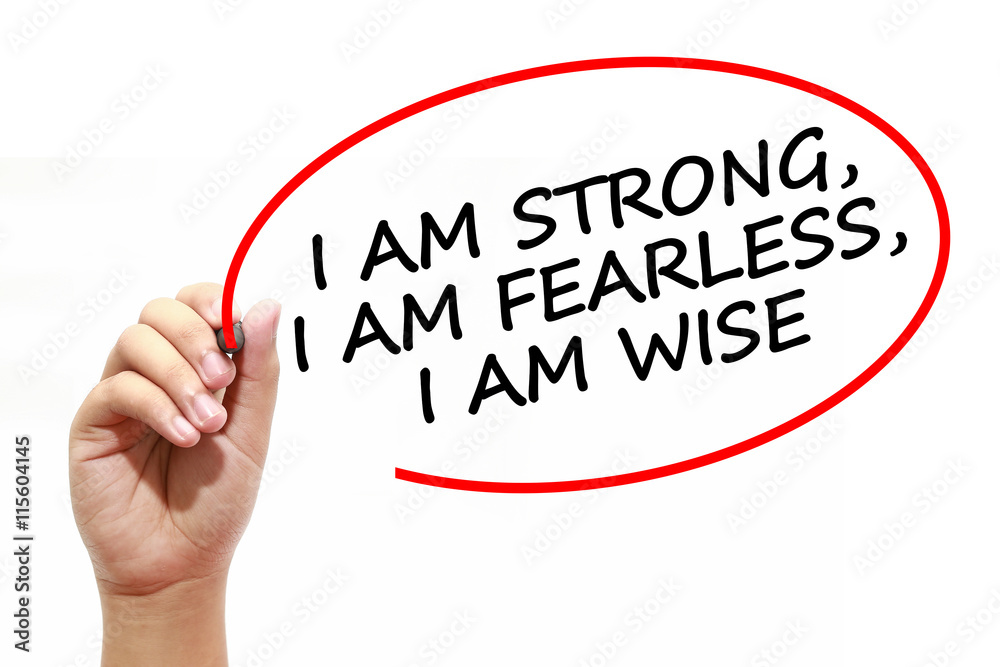 Man writing I AM STRONG, I AM FEARLESS, I AM WISE with marker on transparent wipe board. Man writing I AM STRONG, I AM FEARLESS, I AM WISE with marker on transparent wipe board.