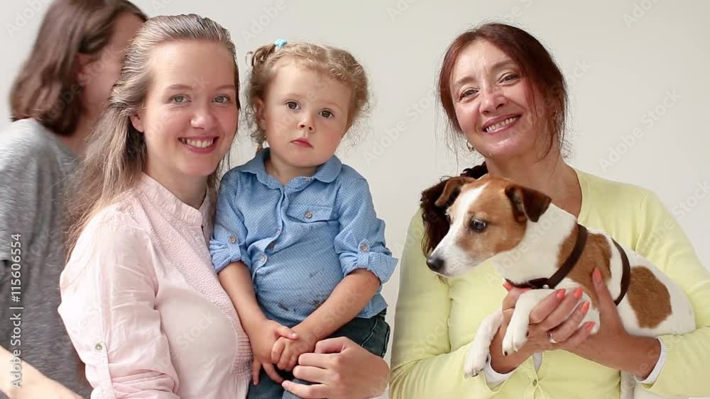 Family of four women and dog smile and laugh Family of four women and dog smile and laugh