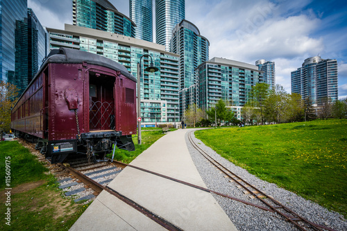 Photography Railroad car at Roundhouse Park and modern buildings in downtown
