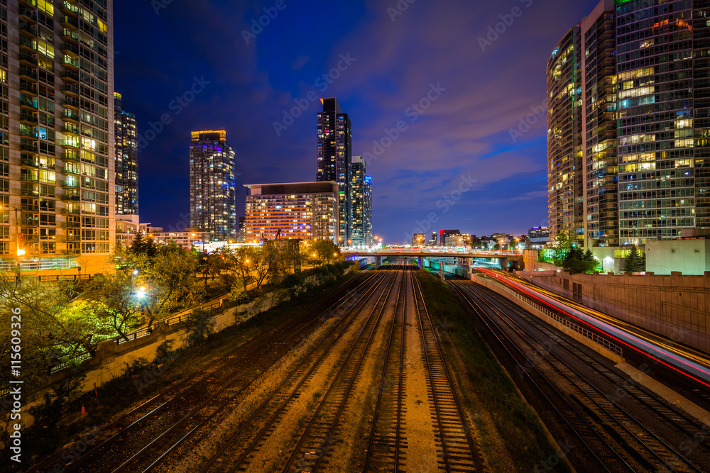 Railroad tracks and modern buildings at night, in downtown Toron