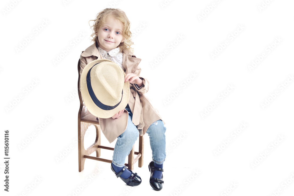Fashionable child. Blonde girl in a stylish raincoat and hat. Fashionable child. Blonde girl in a stylish raincoat and hat.