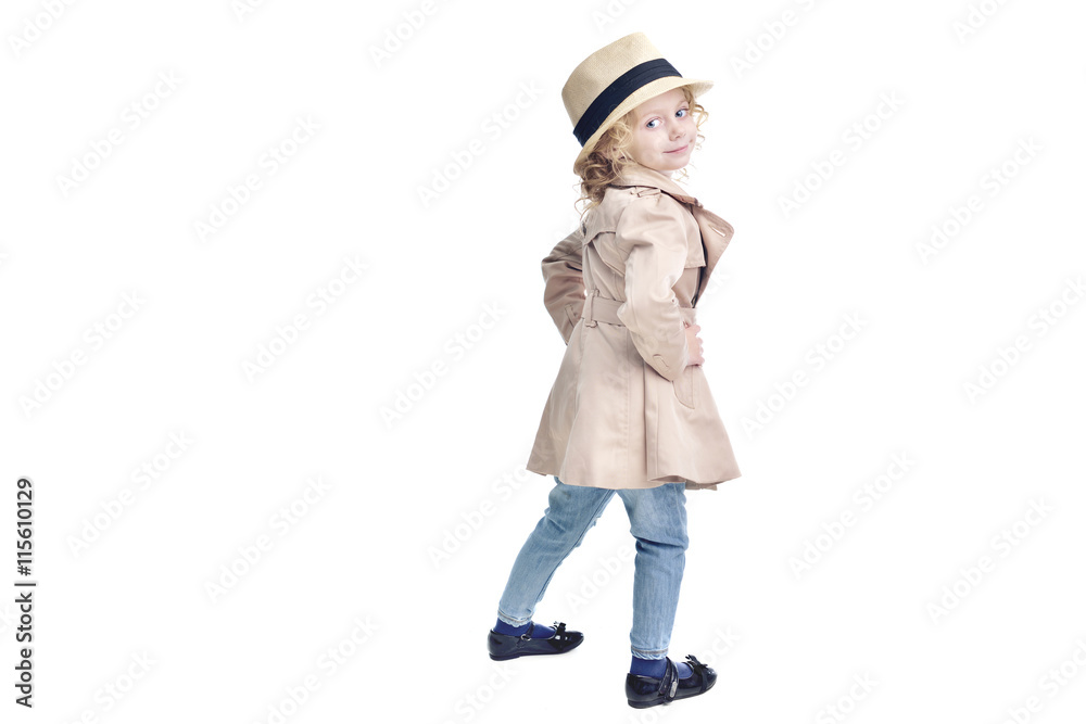 Fashionable child. Blonde girl in a stylish raincoat and hat. Fashionable child. Blonde girl in a stylish raincoat and hat.