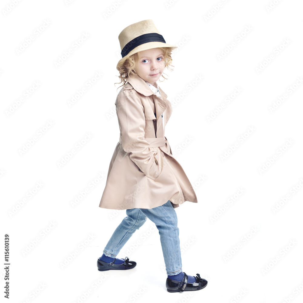 Fashionable child. Blonde girl in a stylish raincoat and hat. Fashionable child. Blonde girl in a stylish raincoat and hat.