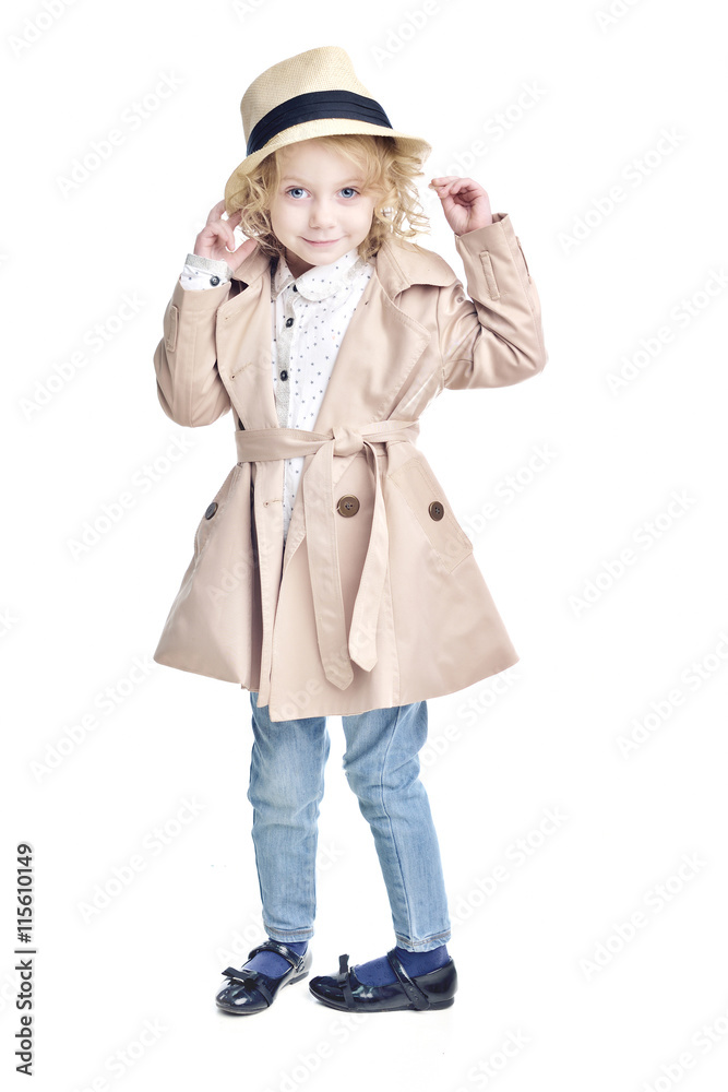Fashionable child. Blonde girl in a stylish raincoat and hat. Fashionable child. Blonde girl in a stylish raincoat and hat.