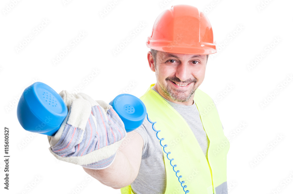 Attractive smiling builder giving a retro receiver Attractive smiling builder giving a retro receiver