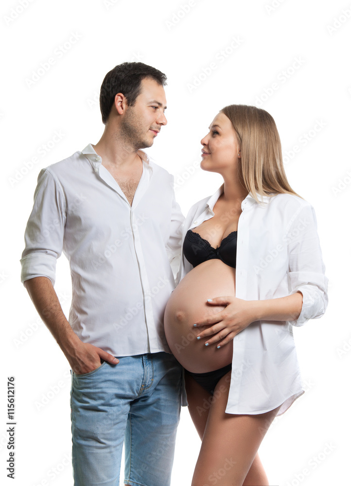 Beautiful young couple expecting baby. A happy family. Isolation on a white background. Pregnancy, childbirth. Beautiful young couple expecting baby. A happy family. Isolation on a white background. Pregnancy, childbirth.