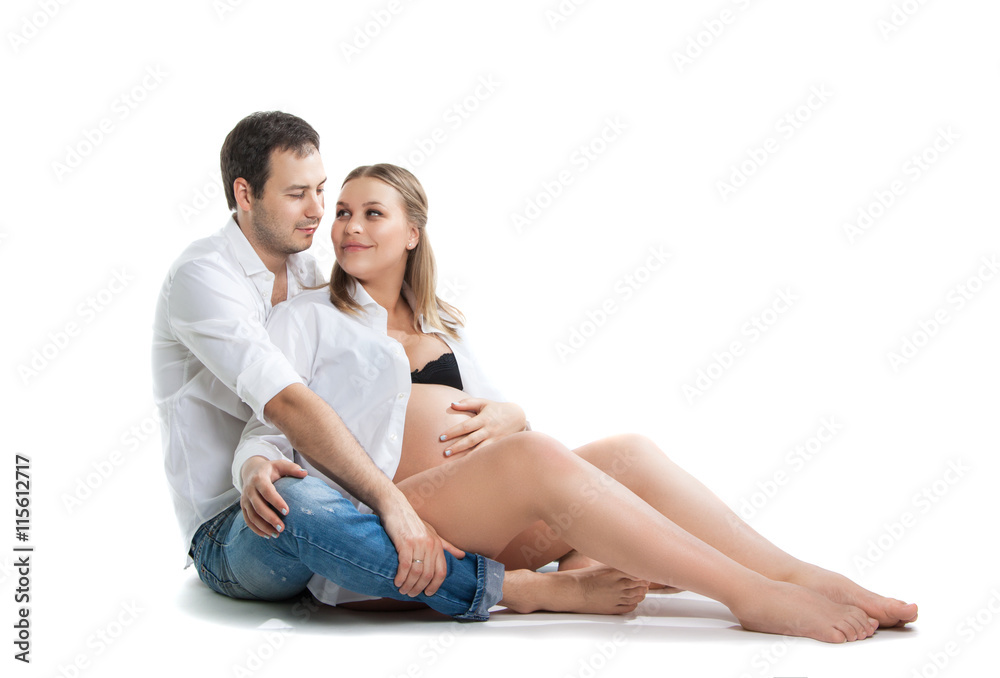 Beautiful young couple expecting baby. A happy family. Isolation on a white background. Pregnancy, childbirth. Beautiful young couple expecting baby. A happy family. Isolation on a white background. Pregnancy, childbirth.