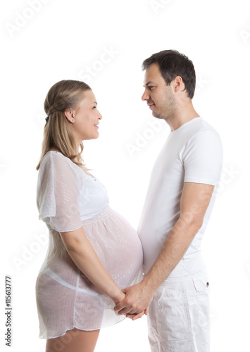 Portrait of happy couple waiting for a baby. Attractive man and woman on a white background. Pregnancy, family, childbirth