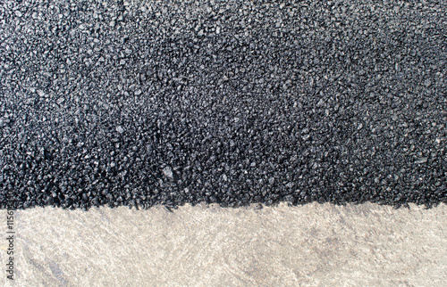 The texture of fresh asphalt lined up close. Pavement