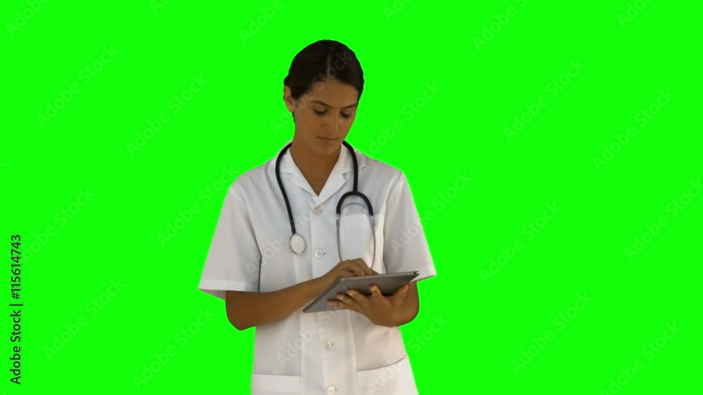 Nurse using her tablet pc on green screen background Nurse using her tablet pc on green screen background
