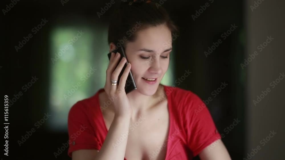 Woman talking on the phone at home. Woman talking on the phone at home.