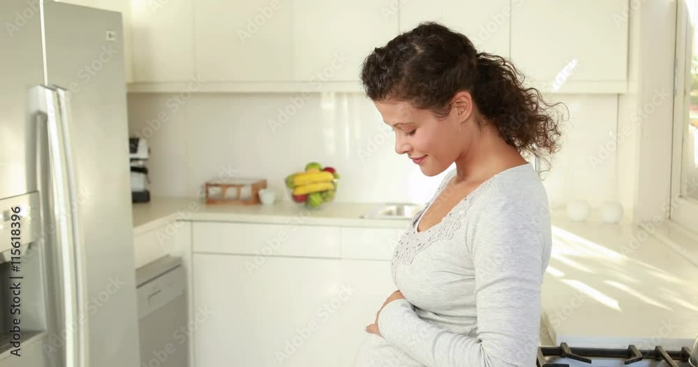 Pregnant woman in the kitchen Pregnant woman in the kitchen