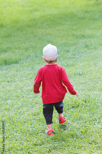 Little boy run on the grass...