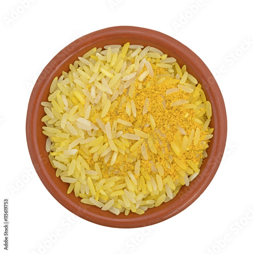 Saffron yellow rice in a bowl top view isolated on a white background.