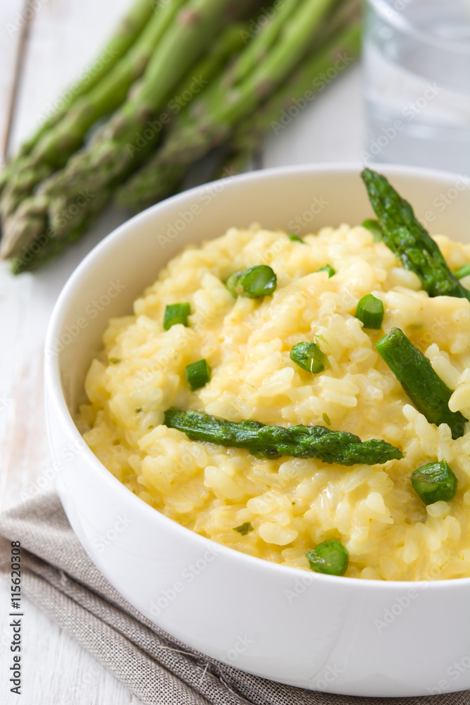 Risotto with asparagus, parsley and peas on a white wooden table
Risotto with asparagus, parsley and peas on a white wooden table