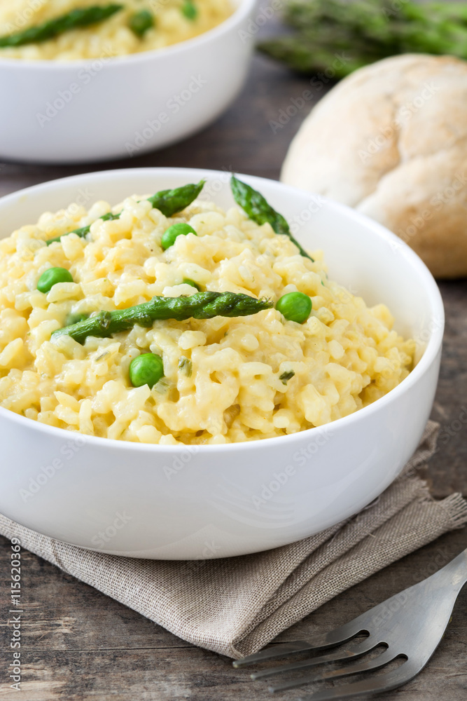 Risotto with asparagus, parsley and peas on a rustic wooden table
Risotto with asparagus, parsley and peas on a rustic wooden table