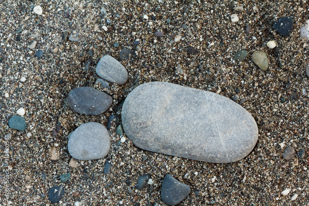Group of foot by pebble on sand background Group of foot by pebble on sand background