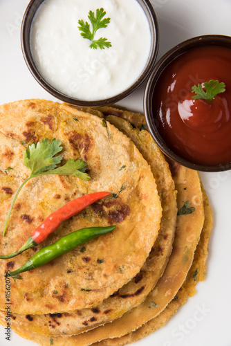 Traditional Indian bread-Aloo paratha ,potato stuffed bread. served with tomato ketchup or sauce and curd