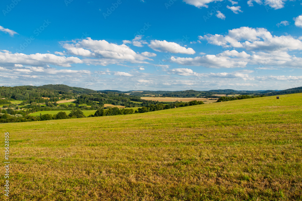 Summer hilly landscape withe green field, forests, blue sky and white clouds, Central Bohemia, Czech Republic Summer hilly landscape withe green field, forests, blue sky and white clouds, Central Bohemia, Czech Republic