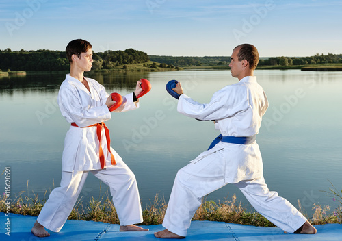 Sister and brother practicing karate near the river