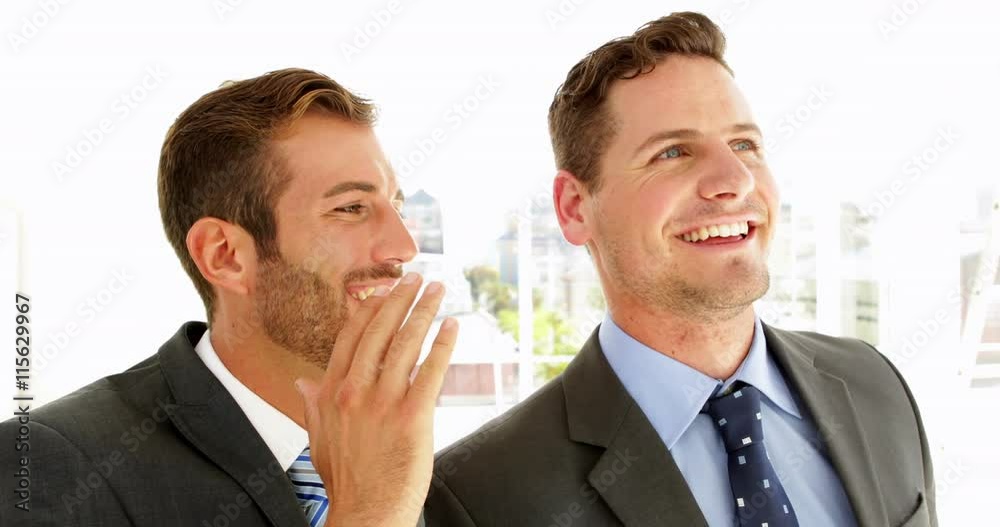 Smiling businessmen chatting together Smiling businessmen chatting together