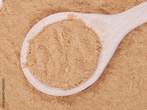 Mesquite powder in wooden spoon