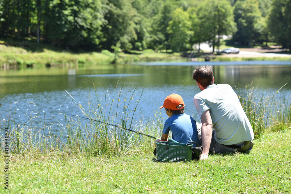 Dad with little boy fishing by mountain lake Dad with little boy fishing by mountain lake