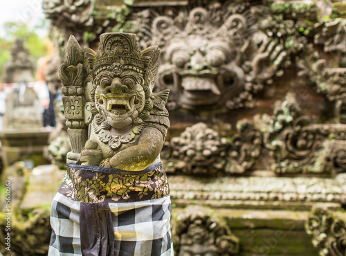 Traditional demon guards statue carved in stone on Bali. © De Visu