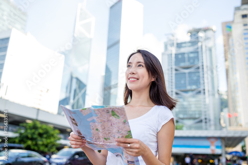 Photography Woman holding a city map in Hong Kong city