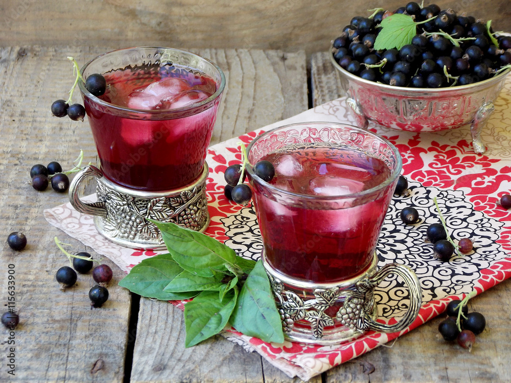 Fresh currant juice or compote with black currant on table Fresh currant juice or compote with black currant on table