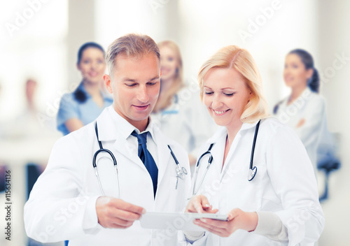two doctors looking at tablet pc