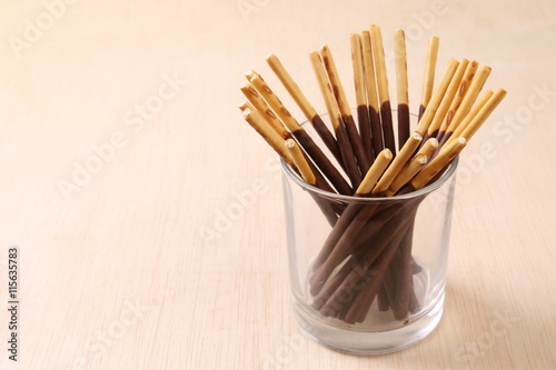 Chocolate dipped biscuits sticks in glass holder