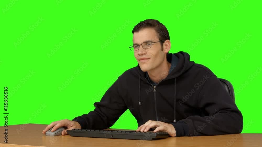 Businessman typing at his desk on green screen background Businessman typing at his desk on green screen background