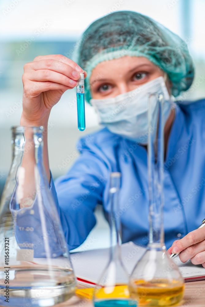 Experienced lab assistant working on chemical solutions Experienced lab assistant working on chemical solutions