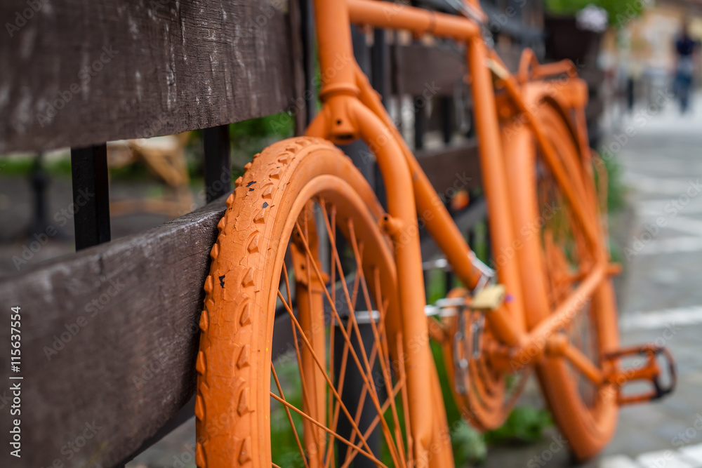 Color picture of a orange painted bicycle