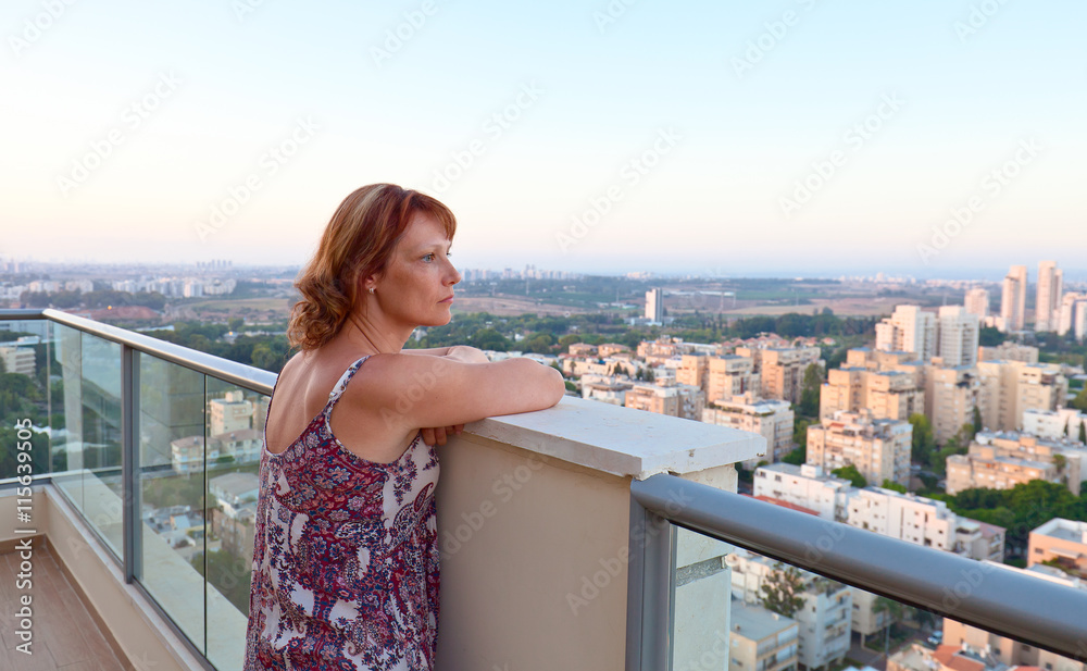Woman on a balcony in downtown