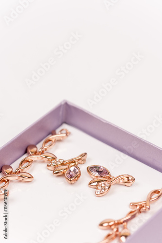 Macro image of golden earrings with diamond stones