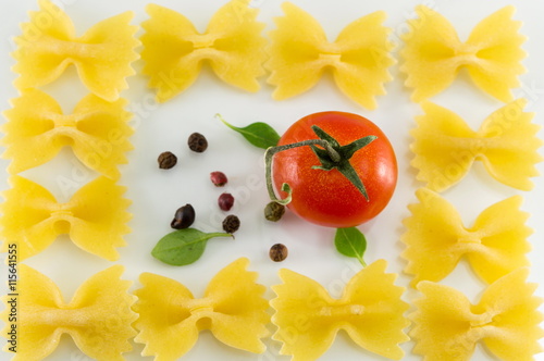 Farfalle pasta forming shapes on white background