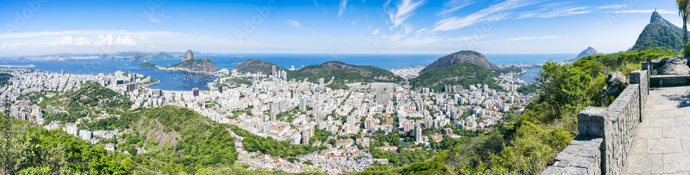 Scenic panorama of the Rio de Janeiro, Brazil city skyline with Sugarloaf Mountain Botafogo and Guanabara Bay under bright blue Brazilian skies