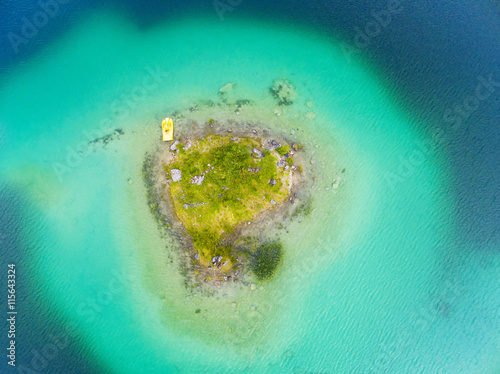 Aerial view to green island in blue sea. Natural background from tropical destination.