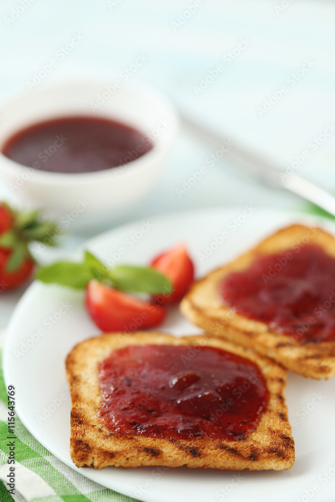 French toasts with jam and strawberry on wooden table French toasts with jam and strawberry on wooden table