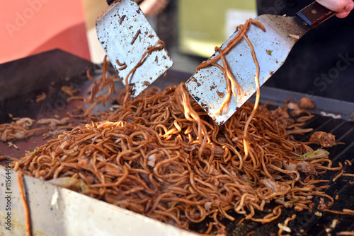 Cook prepare stir fried noodles