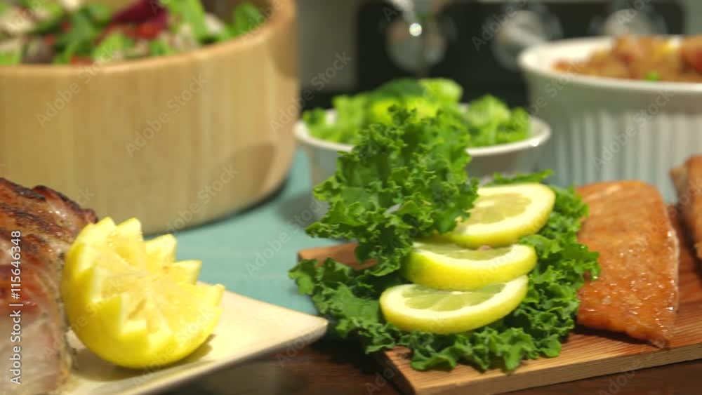 Food Variety on Table for Party. camera moves right on a variety of food on a table. Pork roast, salmon, sushi, chicken, asparagus, garnish
Food Variety on Table for Party. camera moves right on a variety of food on a table. Pork roast, salmon, sushi, chicken, asparagus, garnish